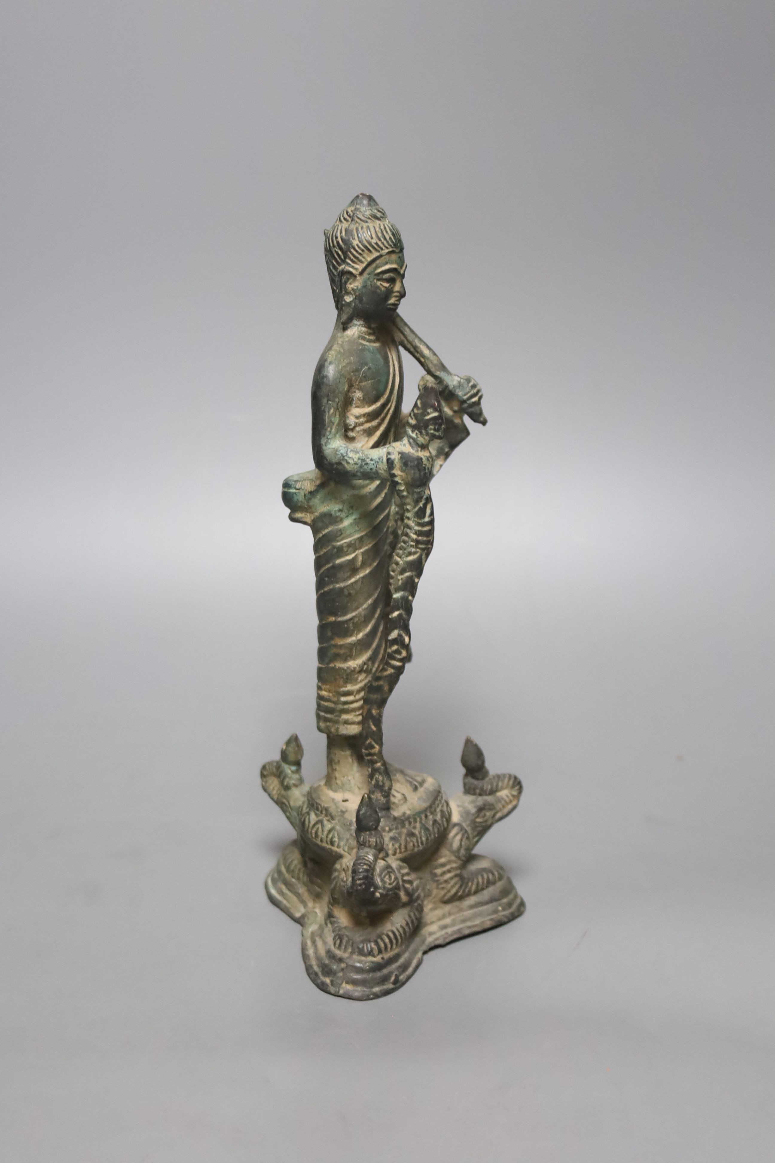 An Indian bronze figure of a standing Buddha, 25cm